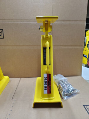 A Yellow Jack Is Positioned Atop a Cardboard Box, Showcasing Its Vibrant Color Against the Neutral Background.