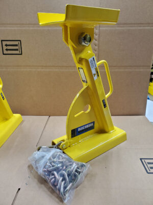 A Yellow Hydraulic Jack Placed on a Table Next to a Bag of Screws, Showcasing Tools for Mechanical Tasks.