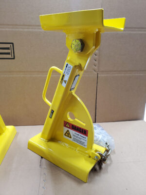 A Yellow Hydraulic Jack Placed on a Box, Emphasizing Its Role in Mechanical Tasks and Equipment Maintenance.