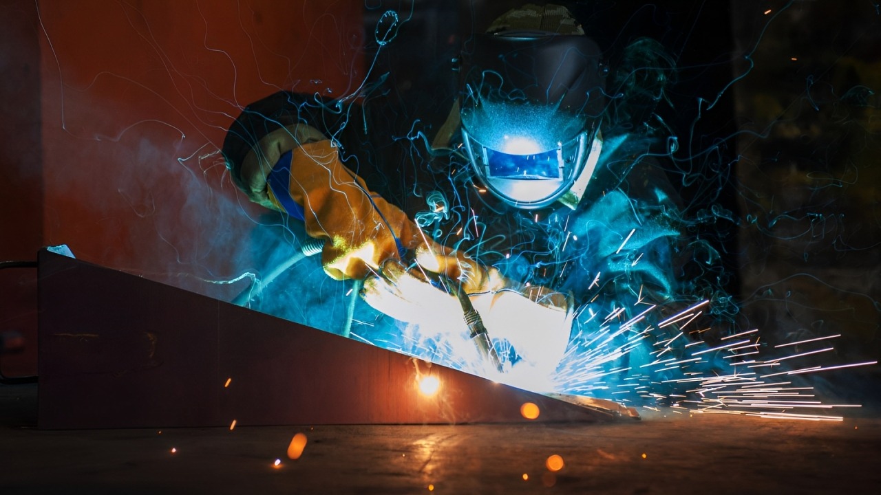 A Man Welding Metal, Creating Bright Sparks as He Works on the Surface, Showcasing Skill and Precision in His Craft.