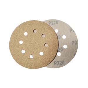 Close-up of a front and back of velcro type sanding disc, with holes for dust collection